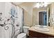 Clean bathroom with a floral shower curtain, and a modern sink and vanity at 25850 E 3Rd Ave, Aurora, CO 80018