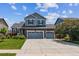 Charming two-story home with a brick facade, well-maintained lawn, and a spacious three-car garage at 25850 E 3Rd Ave, Aurora, CO 80018