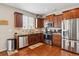 Well-equipped kitchen with stainless steel appliances, granite countertops, and ample cabinet space at 25850 E 3Rd Ave, Aurora, CO 80018