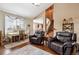 Inviting living room showcasing hardwood floors and staircase to the upper level at 25850 E 3Rd Ave, Aurora, CO 80018