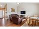 Cozy living room with vaulted ceilings, hardwood floors, and comfortable leather seating at 25850 E 3Rd Ave, Aurora, CO 80018
