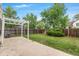 Private backyard with a well-maintained lawn, concrete patio, and white pergola, ideal for relaxation at 5991 W 68Th Ave, Arvada, CO 80003