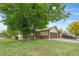Charming home with lush green lawn and mature trees, offering great curb appeal at 5991 W 68Th Ave, Arvada, CO 80003