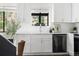 Stylish kitchen featuring white cabinets, stainless steel faucet, and tiled backsplash at 5991 W 68Th Ave, Arvada, CO 80003