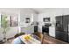 Modern kitchen featuring white cabinets, quartz countertops, and stainless steel appliances at 5991 W 68Th Ave, Arvada, CO 80003
