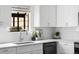 Bright kitchen with white cabinets, quartz countertops, and stainless steel appliances at 5991 W 68Th Ave, Arvada, CO 80003