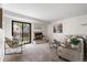 Bright living room with fireplace, neutral decor, and sliding door to the backyard at 5991 W 68Th Ave, Arvada, CO 80003