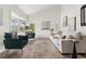 Spacious living room with large windows, comfortable seating, and stylish decor at 5991 W 68Th Ave, Arvada, CO 80003
