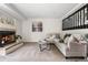 Cozy living room features a fireplace, comfortable seating, and a stylish round coffee table at 5991 W 68Th Ave, Arvada, CO 80003