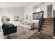 Bright living room with tall ceilings, hardwood floors, neutral tones, and modern staircase at 5991 W 68Th Ave, Arvada, CO 80003