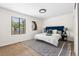 Cozy bedroom with neutral walls, a large window, and a stylish blue headboard at 5991 W 68Th Ave, Arvada, CO 80003