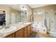 This bathroom features double sinks, separate shower and tub, and granite countertops at 1038 Petras St, Erie, CO 80516