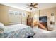 This sun filled primary bedroom features a ceiling fan and an ensuite bathroom at 1038 Petras St, Erie, CO 80516