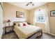 This bright bedroom features neutral paint, a ceiling fan and ample sunlight at 1038 Petras St, Erie, CO 80516