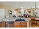 Open kitchen featuring a granite island with bar seating and stainless steel dishwasher at 1038 Petras St, Erie, CO 80516