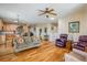 Open living space featuring hardwood floors, a ceiling fan, and a staircase at 1038 Petras St, Erie, CO 80516