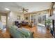 Bright living room with hardwood floors, a ceiling fan, and access to the backyard at 1038 Petras St, Erie, CO 80516