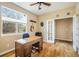 Bright home office with hardwood floors, a large window, and a classic wooden desk at 1038 Petras St, Erie, CO 80516