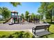 Community playground with slides, climbing structures, and a bench at 1038 Petras St, Erie, CO 80516