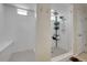 This spacious bathroom features a walk-in shower with built-in seating and updated fixtures at 4733 S Wenatchee Cir, Aurora, CO 80015