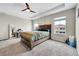 This spacious bedroom features a wooden bed frame, ceiling fan, and great natural light at 4733 S Wenatchee Cir, Aurora, CO 80015