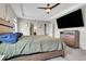 This bedroom features a spacious room with a large tv and a ceiling fan at 4733 S Wenatchee Cir, Aurora, CO 80015
