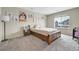 Cozy bedroom featuring a wooden bed frame, carpet flooring and natural light from the window at 4733 S Wenatchee Cir, Aurora, CO 80015