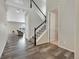 Bright entryway with wood floors, staircase with white railings, and adjacent sitting room at 4733 S Wenatchee Cir, Aurora, CO 80015