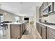 Kitchen with island, stainless steel appliances, wood floors, and an open layout to the living room at 4733 S Wenatchee Cir, Aurora, CO 80015