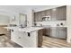 Kitchen island with a breakfast bar, stainless steel appliances, white countertop and wood-look floors at 4733 S Wenatchee Cir, Aurora, CO 80015