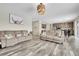 Bright living room featuring hardwood floors, modern lighting and a large window with natural light at 4733 S Wenatchee Cir, Aurora, CO 80015