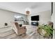 Living room with wood flooring, two reclining love seats, and a large flat screen TV at 4733 S Wenatchee Cir, Aurora, CO 80015