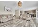 Bright living room with wood-look flooring, recessed lighting, and comfortable seating at 4733 S Wenatchee Cir, Aurora, CO 80015