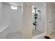 Modern shower with white subway tile, a built-in bench, and glass enclosure at 4733 S Wenatchee Cir, Aurora, CO 80015