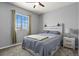 Well-lit bedroom with plush carpeting, ceiling fan, and modern decor at 1794 Wright Dr, Erie, CO 80516