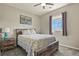 Bedroom with a window, ceiling fan, and a wood-framed bed, perfect for relaxation at 1794 Wright Dr, Erie, CO 80516