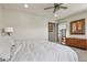 Bedroom with a white bed and wood dresser beneath artwork on the wall at 1794 Wright Dr, Erie, CO 80516