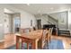 Dining room with a wood table and chairs set on a hardwood floor, as well as a piano at 1794 Wright Dr, Erie, CO 80516