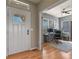 Entryway view leading to the study with wood floors, natural light, and modern features at 1794 Wright Dr, Erie, CO 80516