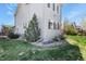 Side view of home with landscaped yard and multiple windows at 1794 Wright Dr, Erie, CO 80516