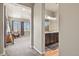 Hallway view of a bathroom with a vanity and a bedroom featuring an accent chair at 1794 Wright Dr, Erie, CO 80516