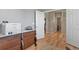 Hallway view features hardwood floors, natural light, and classic wood dresser at 1794 Wright Dr, Erie, CO 80516