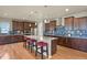 Gourmet kitchen features a large center island with bar seating, custom cabinetry, and stainless steel appliances at 1794 Wright Dr, Erie, CO 80516