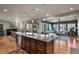 The open kitchen features granite countertops, a center island with bar seating, and easy access to the living spaces at 1794 Wright Dr, Erie, CO 80516