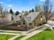 Aerial view of a well-maintained home featuring a landscaped lawn and long driveway at 4829 Baldwin Pl, Boulder, CO 80301