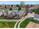 An aerial shot of a home with a fenced backyard, driveway, and mature trees at 4829 Baldwin Pl, Boulder, CO 80301