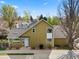 Home featuring a landscaped yard, large roof, and white front door at 4829 Baldwin Pl, Boulder, CO 80301