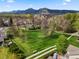 Scenic aerial view of a green space, walking paths and mature trees with mountains in the distance at 4829 Baldwin Pl, Boulder, CO 80301