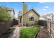 A tranquil fenced backyard with stone walkway, lawn, and landscaping at 4829 Baldwin Pl, Boulder, CO 80301