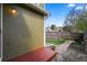 The exterior of a backyard with a lush lawn, red deck, and stone walkway at 4829 Baldwin Pl, Boulder, CO 80301